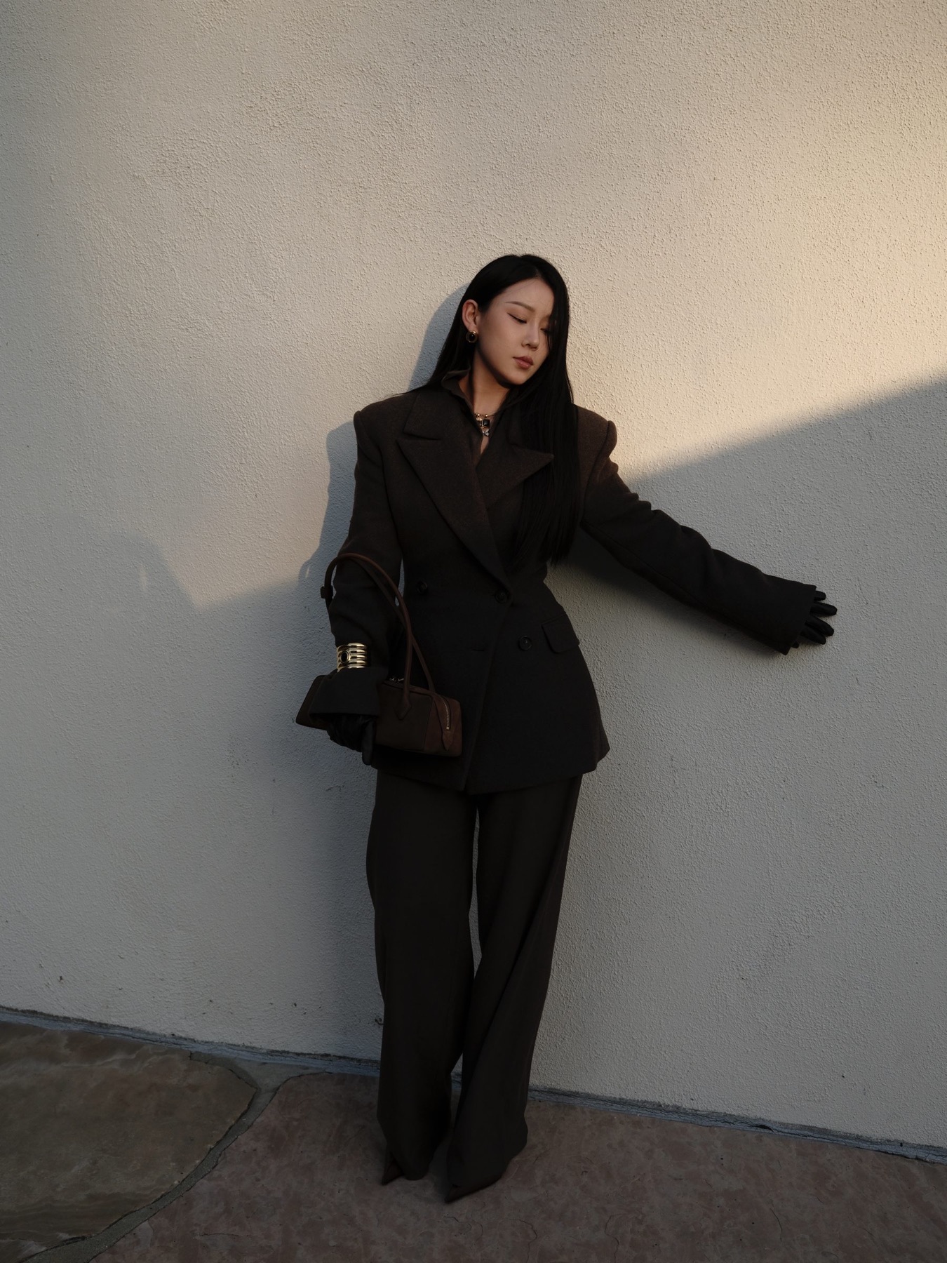 Sharp black suit with a structured bag
