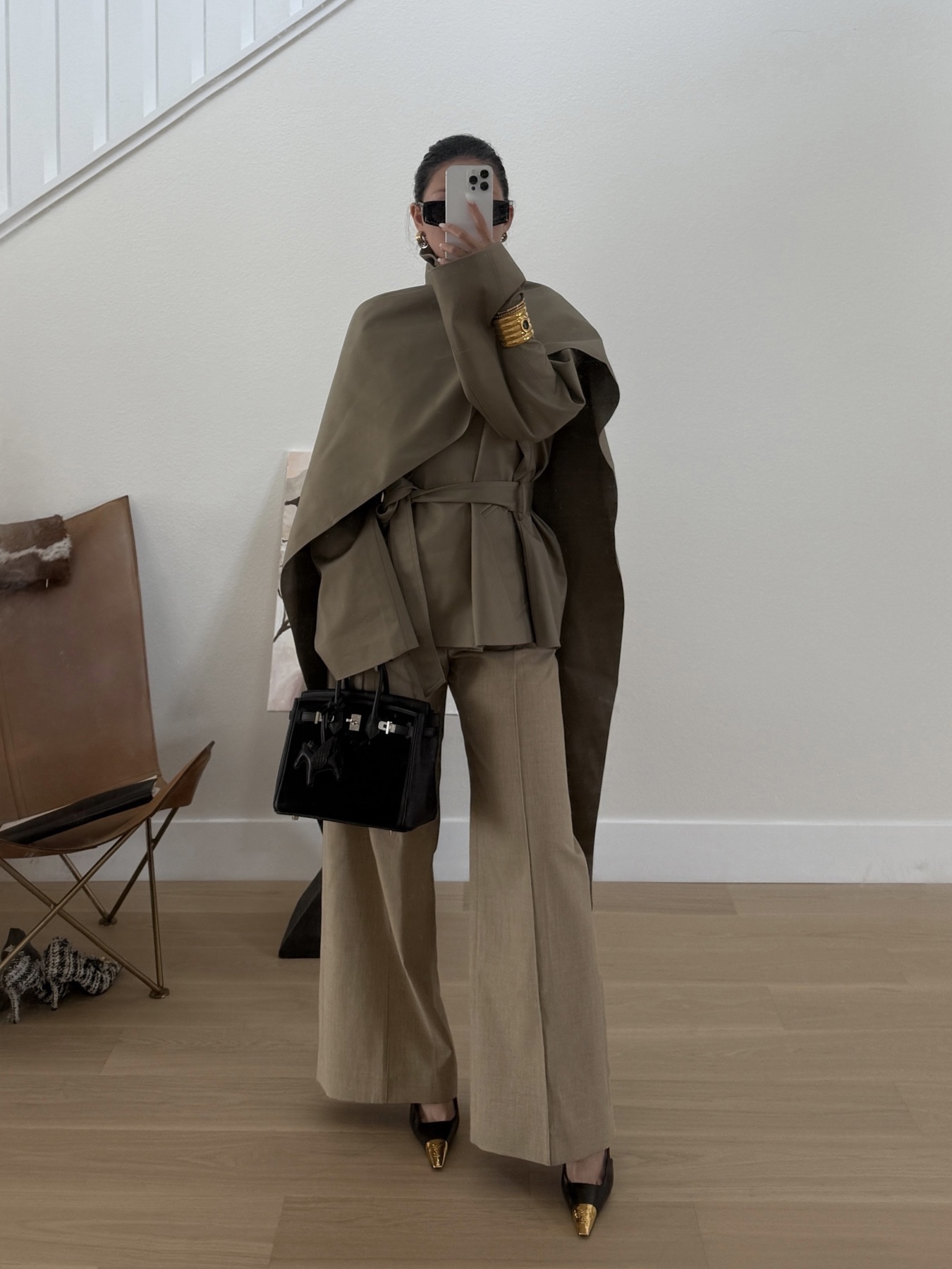 Neutral trench styling in a quiet mirror reflection